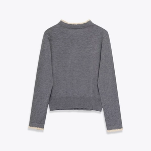 Elegant dark grey knit sweater with long sleeves and white lace trim on cuffs and collar
