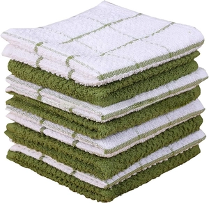 Close-up of stacked cotton waffle kitchen towels with classic green checkered patterns
