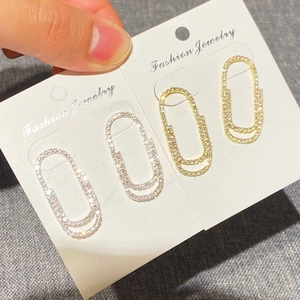 Sparkling full crystal paperclip earrings set in gold and silver finish on white card
