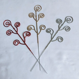 Detail view of glittery Christmas berry branches in red, gold, and silver colors