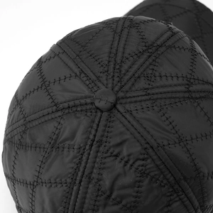 Close-up of quilted diamond pattern and stitching on a winter men's baseball cap