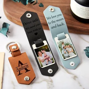 Custom leather photo keychain in brown and black with personalized metal engraving