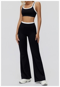 Full body view of high-waist flared yoga pants and black white contrast sports bra set