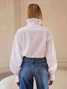 White long-sleeve blouse with ruffle stand collar and vintage design shown from the back