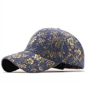 Detailed side view of vintage denim baseball cap with elegant gold floral pattern prints