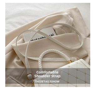 Detailed close-up of white quilted crossbody bag featuring woven handle and gold hardware