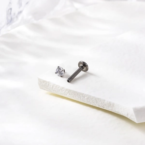 Detailed macro view of G23 titanium piercing stud with 3mm round cubic zirconia inlay