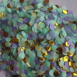 Close-up of circular mint green, lavender, and metallic gold confetti dots for party decor