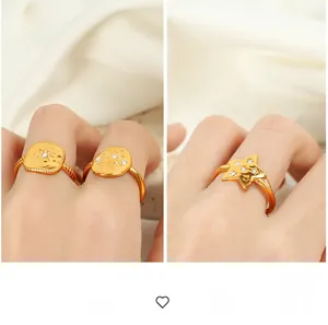 Detailed view of gold plated geometric rings with sunburst patterns and tiny rhinestones