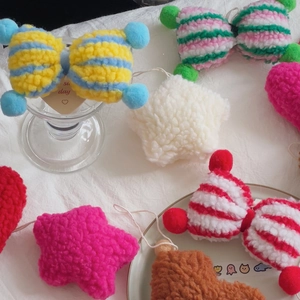 Close-up of soft lamb wool star and heart Christmas ornaments for DIY flower arrangements