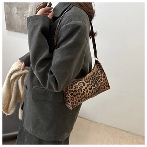 Fashionable leopard print baguette bag styled with a corduroy blazer and beige scarf