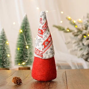 Kerstkabouter met sneeuwvlok gebreide muts op een feestelijke houten tafel decoratie