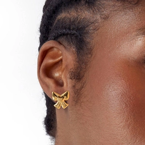 Golden bow stud earrings with heart detail in 14K gold plated titanium steel on ear