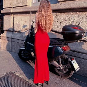 Rear view of sleek red high-waist bodycon maxi dress styled by a motorcycle