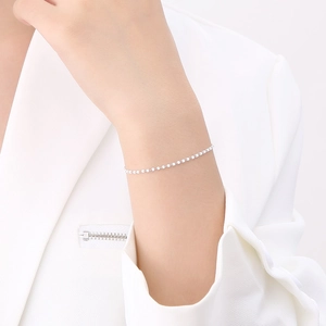 Close-up of minimalist silver stainless steel bead chain bracelet on a wrist