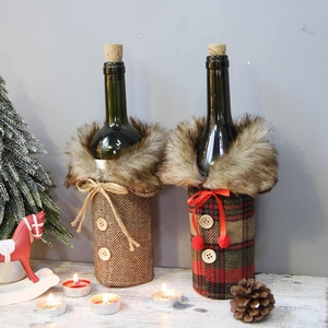 Handmade knitted wine bottle covers with faux fur collars for festive Christmas dining decor