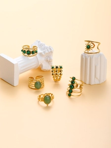 Artistic display of 18k gold plated stainless steel rings with green malachite stones