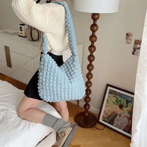 Close-up of light blue bubble textured tote bag showing high-capacity design for women