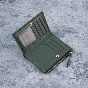 Dark green leather wallet with multiple card slots and a secure golden zipper pocket