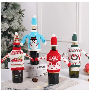 Detail of four creative knitted Christmas wine bottle covers with mini hats on bottles