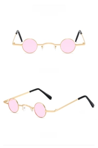 Macro detail of rose gold small round metal sunglasses with pink lenses and black temple tips