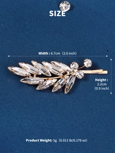 Detailed view of crystal leaf hair clip with dimensions 6.7cm by 2.2cm on blue background