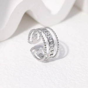 Detail of silver layered chain ring featuring polished beads and adjustable open design
