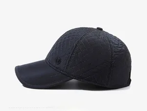 Detail of navy blue quilted baseball cap with diamond stitching and circular logo emblem