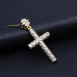 Detail of gold-plated cross pendant with sparkling zircons and a secure box chain