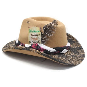 Detail of wide brim western hat with floral ribbon, feather accent and ethnic gold prints