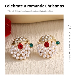 Detailed view of Christmas earrings with red and green stones and pearls on velvet