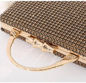 Detail of luxurious champagne crystal evening bag with a segmented metal handle