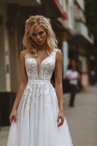 Detailed view of floral lace embroidery and pearl beading on deep V-neck wedding dress