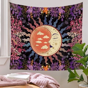 Detail view of square sun and moon tapestry hanging above a cozy sofa in a room
