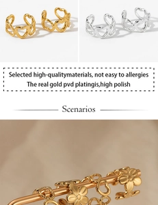 Detailed view of hollow heart and flower ear cuffs in gold and silver finishes