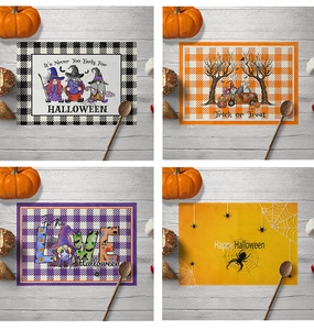 Detail view of Halloween linen placemats with spider and ghost patterns in grid layout