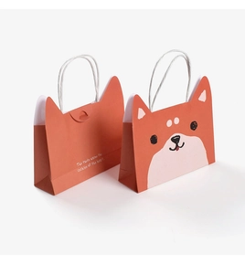 Front and back detail of a cute orange Shiba Inu cartoon paper gift bag with handles