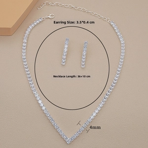 Detail view of square-cut zircon necklace and long earrings set on beige background