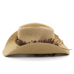 Detail of khaki straw cowboy hat with bohemian feather and bead decoration