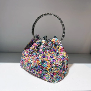 Close-up of bucket bag with colorful crystal embellishments and silver circular handle