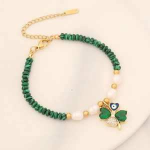 Detail of 18K gold-plated beaded necklace with green malachite, pearls, and clover pendant