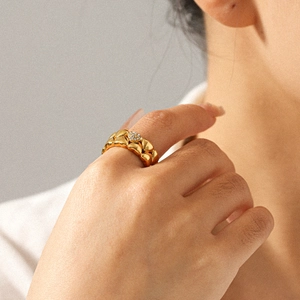 18K gold plated stainless steel intertwined heart ring with diamonds on model hand