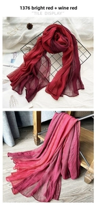 Detail of red and wine red gradient pleated silk scarf with tile display and soft texture