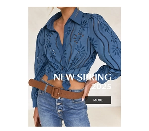 Detail of navy blue blouse showing intricate hollow embroidery and floral lace patterns