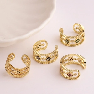 Set of four gold adjustable rings with vibrant zircon stones in a star pattern