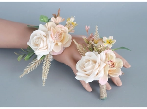 Matching set of cream rose bridal wrist corsage and groom boutonniere with pearl accents