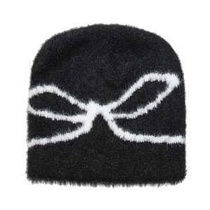Women's black plush beanie with white jacquard bow pattern for winter warmth