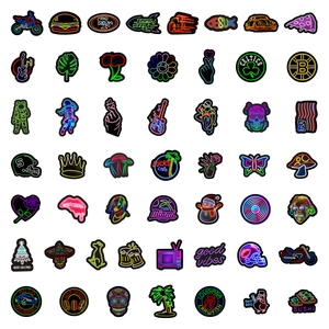 Flat lay of diverse neon style vinyl stickers for laptops and bottles in detail view