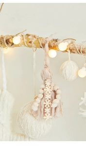 Handmade Christmas wall decoration with pink tassels, cotton balls and warm LED string lights