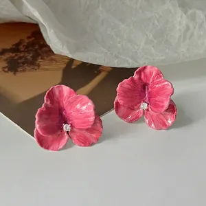 Elegant 14K gold plated pink petal stud earrings with crystal center on white surface